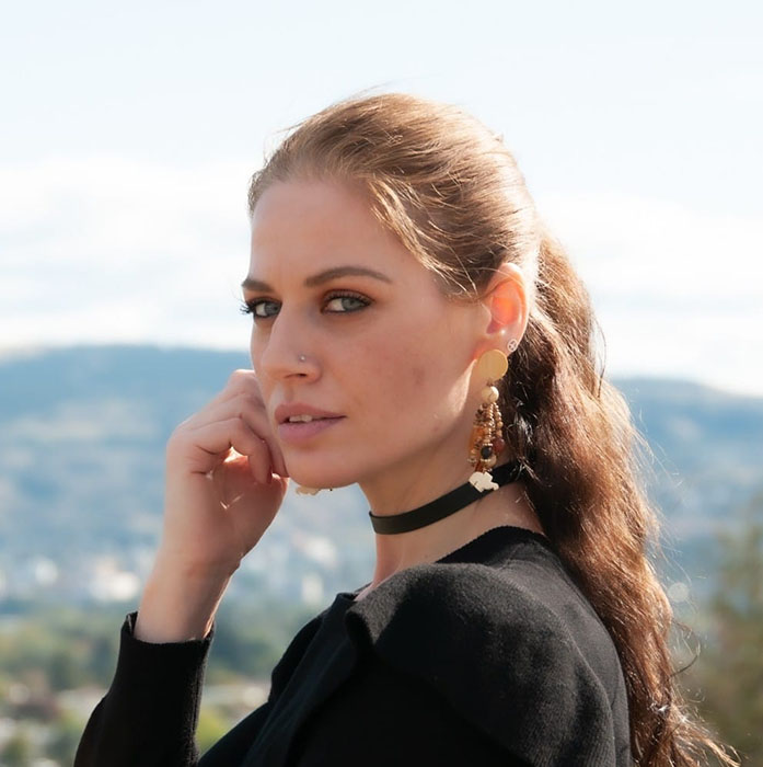 A woman with long hair and a black shirt