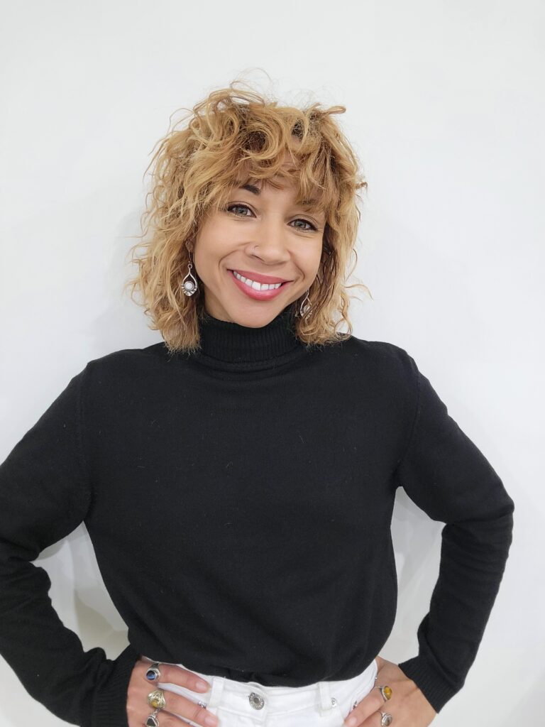 A woman with blonde hair wearing black shirt.