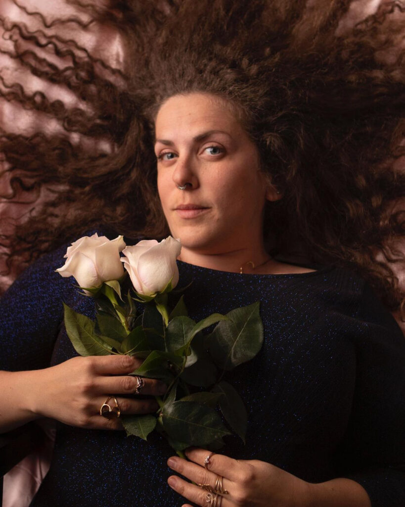 A woman holding roses in her hands.