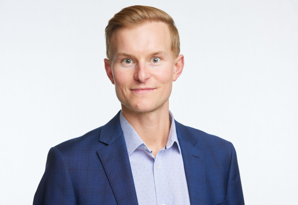 A man in a blue suit and white shirt